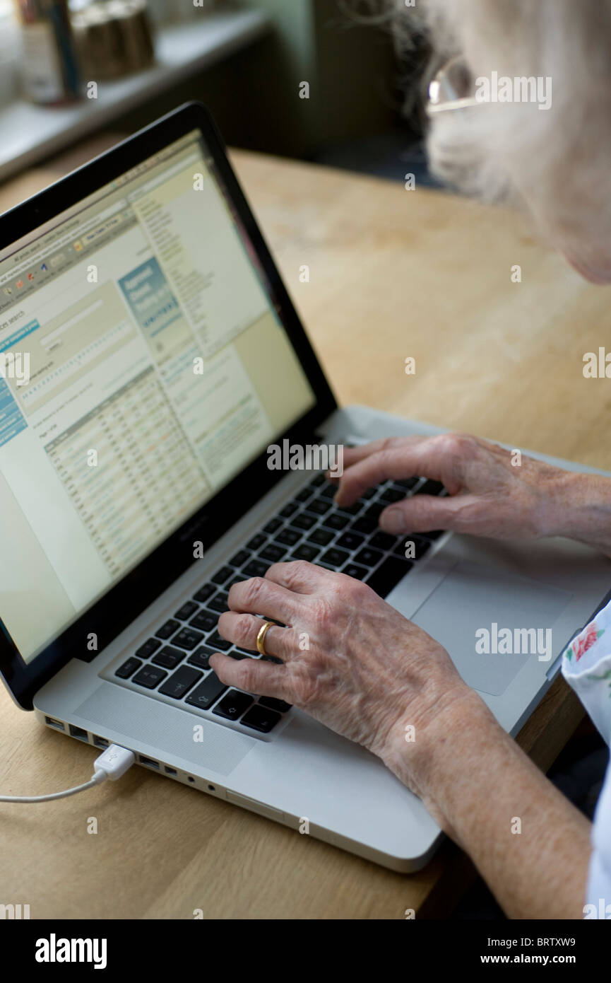 oap using an apple mac computer in her kitchen Stock Photo - Alamy