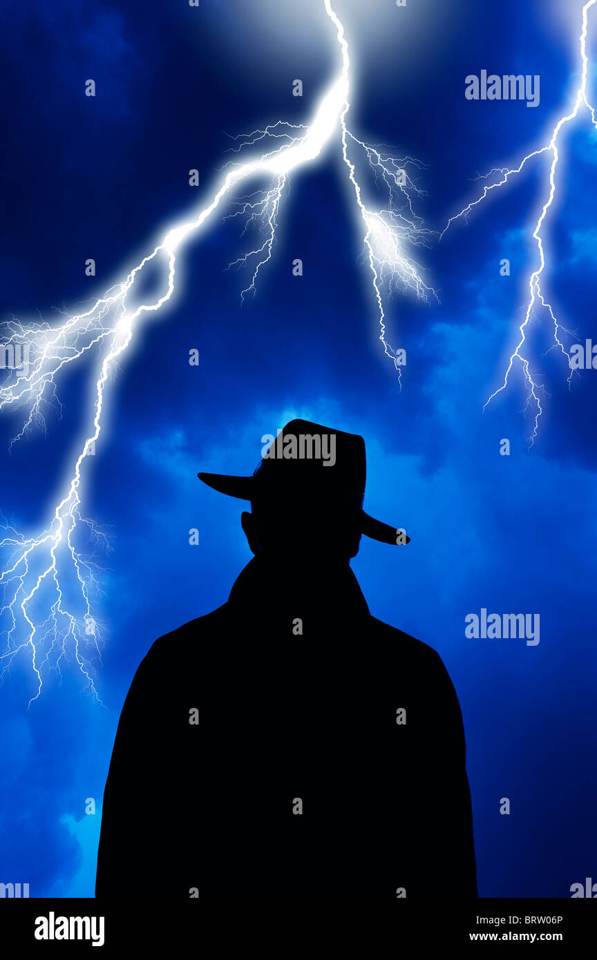 sinister looking bad guy facing lightning storm Stock Photo