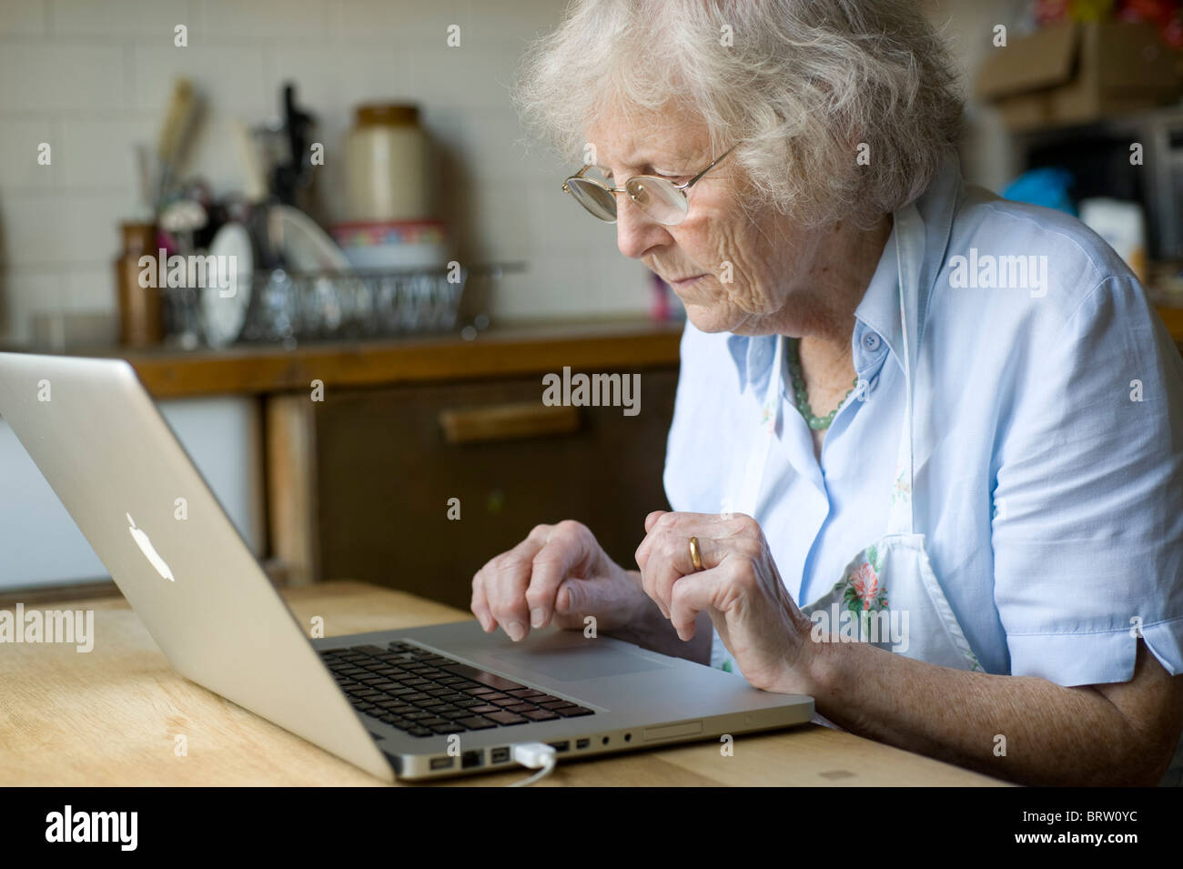 oap using an apple mac computer in her kitchen Stock Photo - Alamy