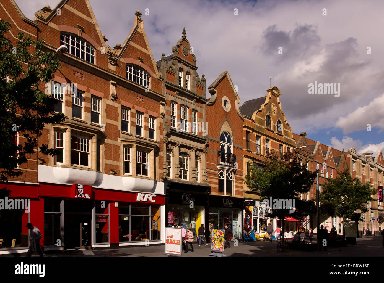 Attractive ornate architecture above shop fronts on the pedestrianised High Street in Leicester City Centre. Stock Photo