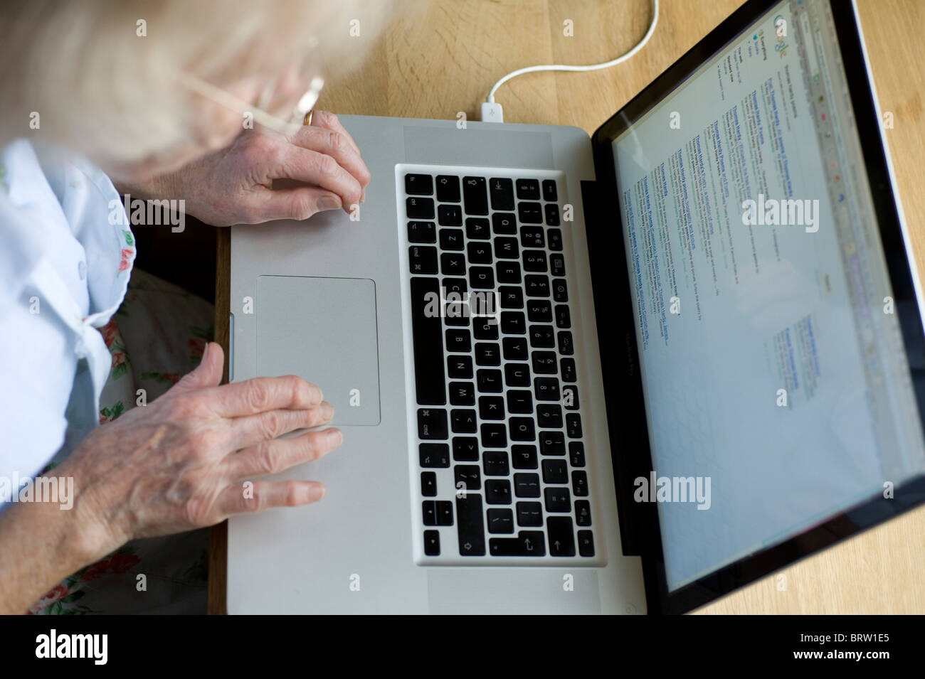 oap using an apple mac computer in her kitchen Stock Photo - Alamy