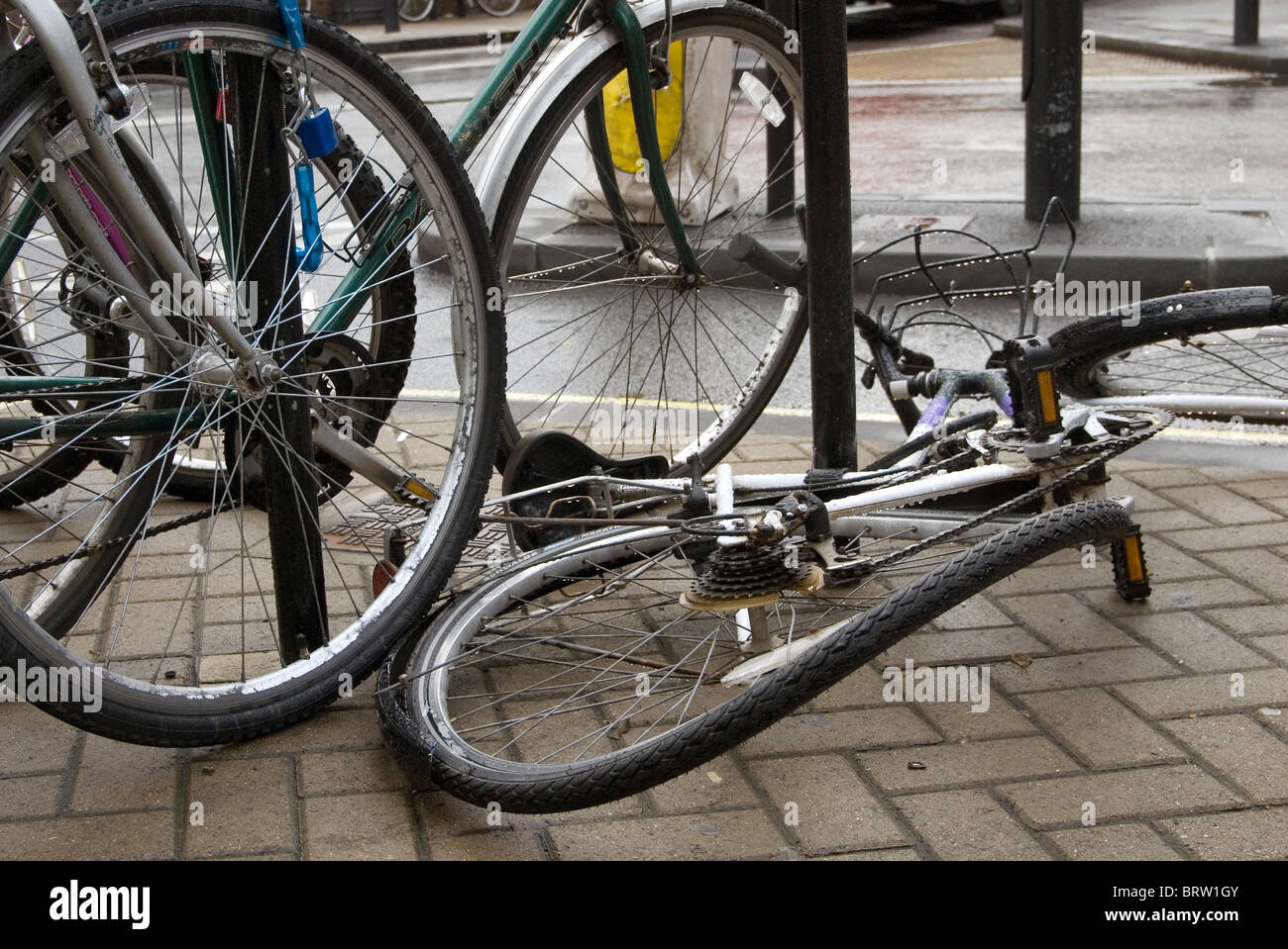 A bicycle that has been vandalised lying on a Cambridge street Stock Photo