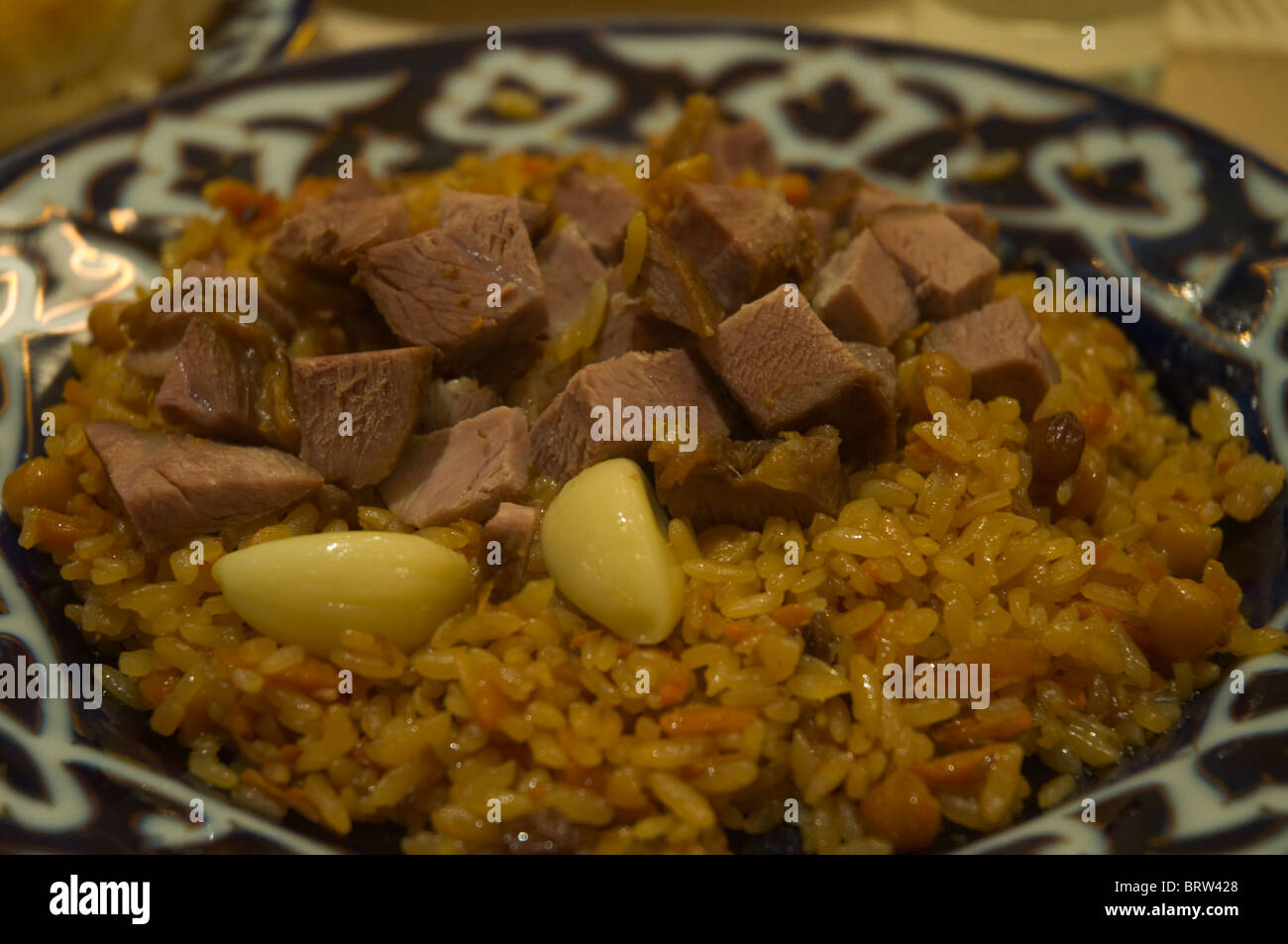 Uzbek plov dish with rice lamb and garlic in an Oriental restaurant