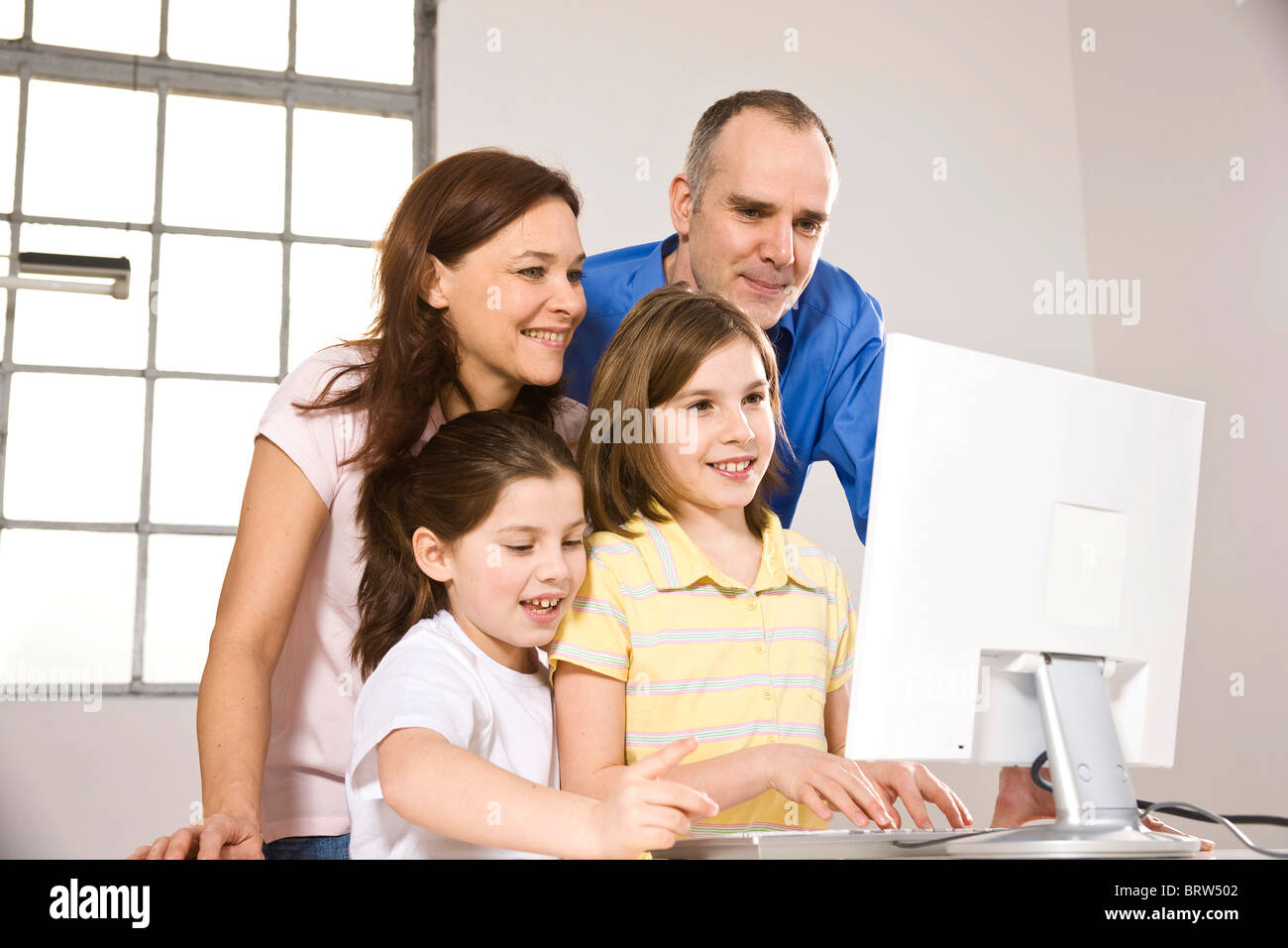 Family in front of a computer together Stock Photo - Alamy