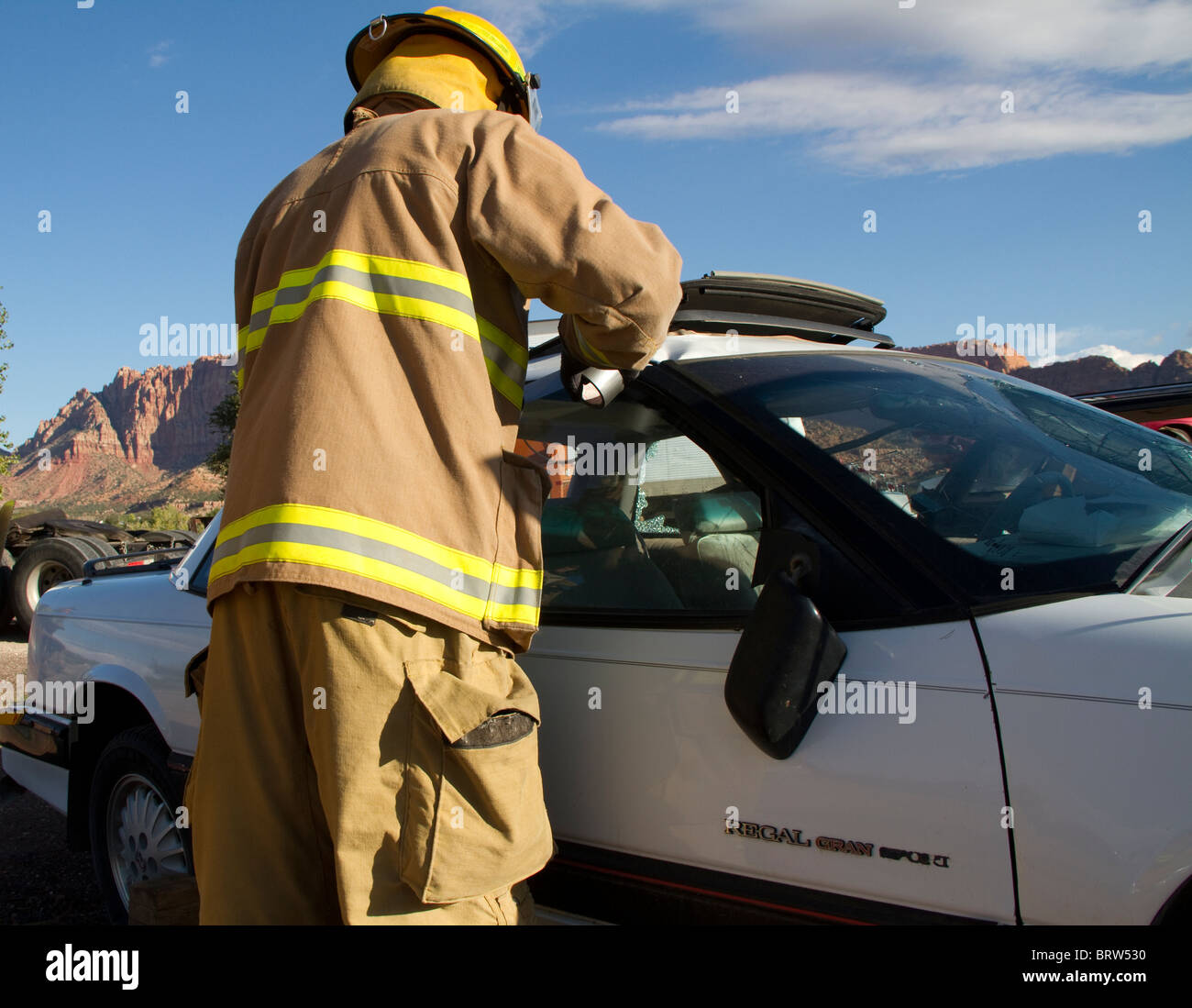 Recruit Firefighter during an extrication drill. Stock Photo