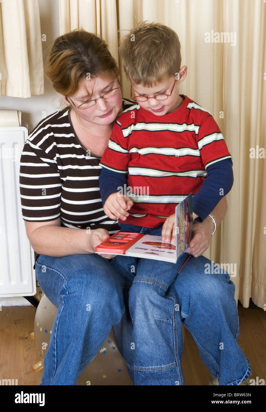 Mother reading book to child Stock Photo