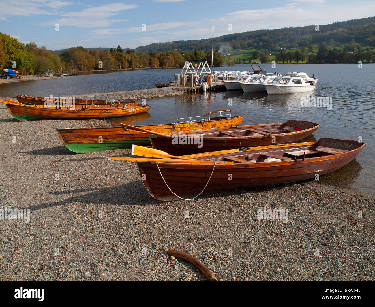 Traditional rowing skiffs and small motor boats for hire at Coniston Water Cumbria England Stock Photo