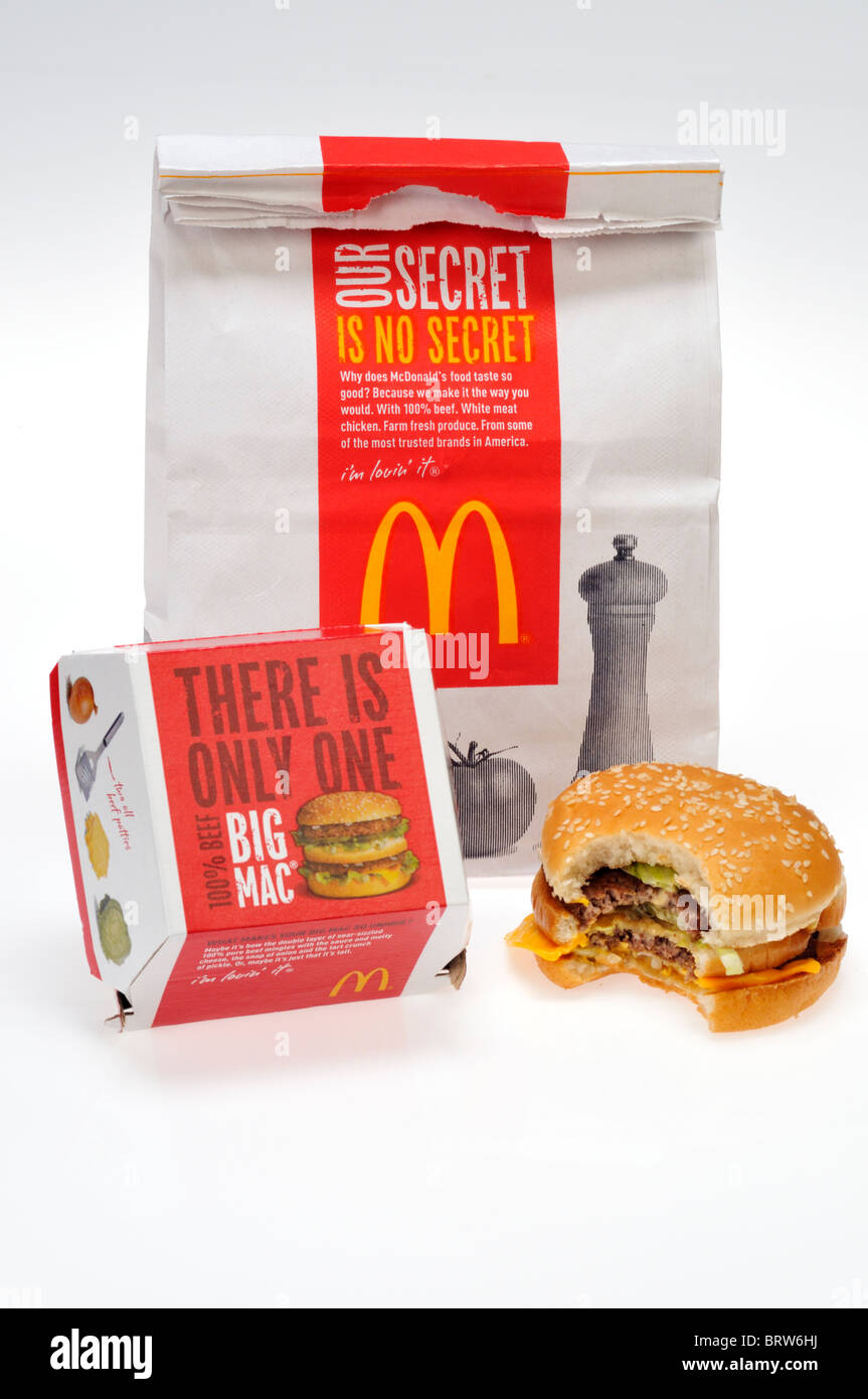 McDonald's bag with a Big Mac that has a bite out of it on white background with carton cut out. Stock Photo