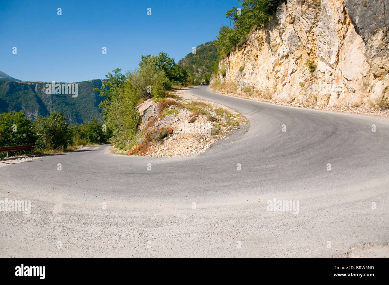 Sharp road curve in high mountains Stock Photo