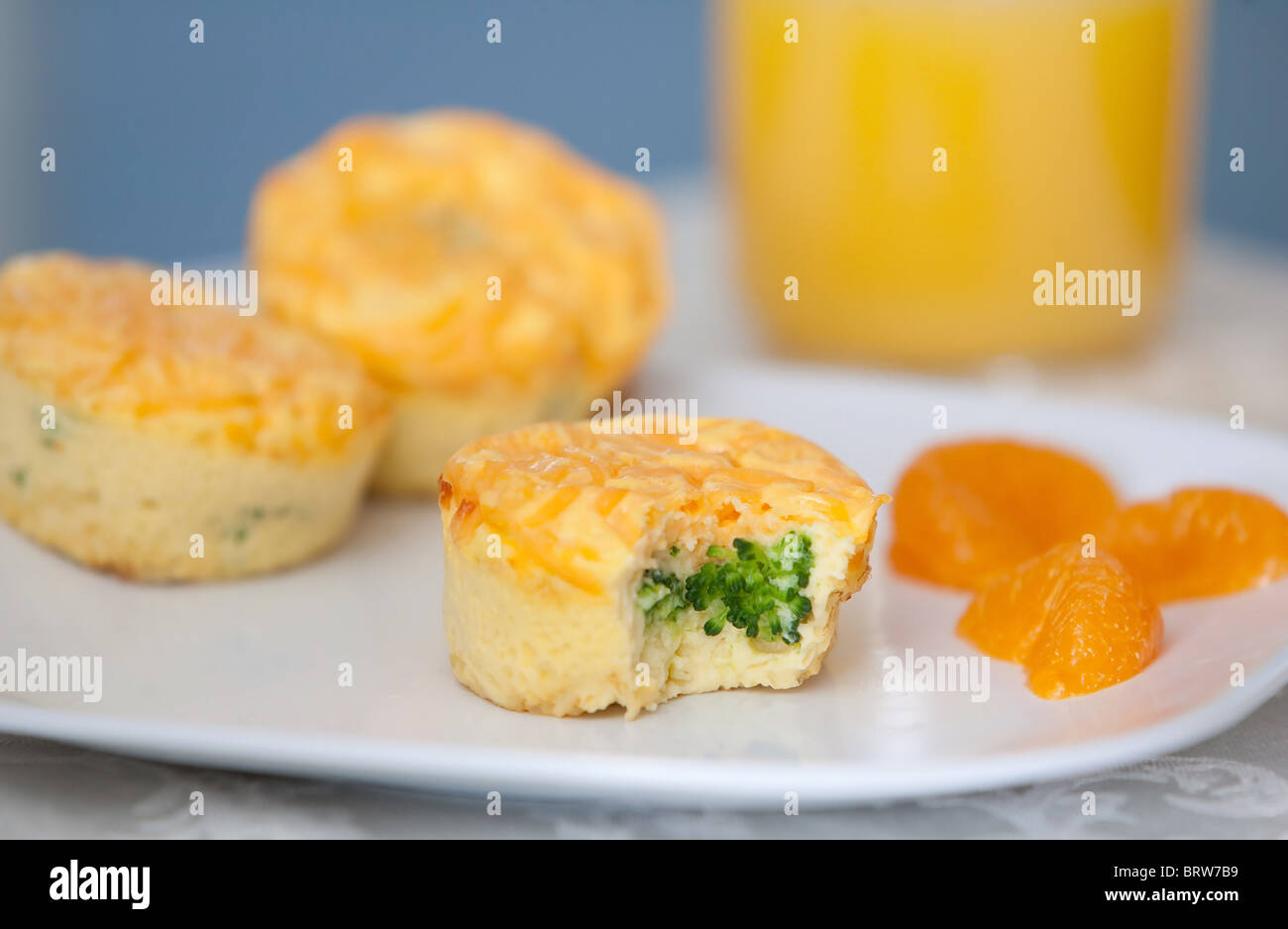 plate of breakfast egg and broccoli muffins with cheese on a white plate Stock Photo