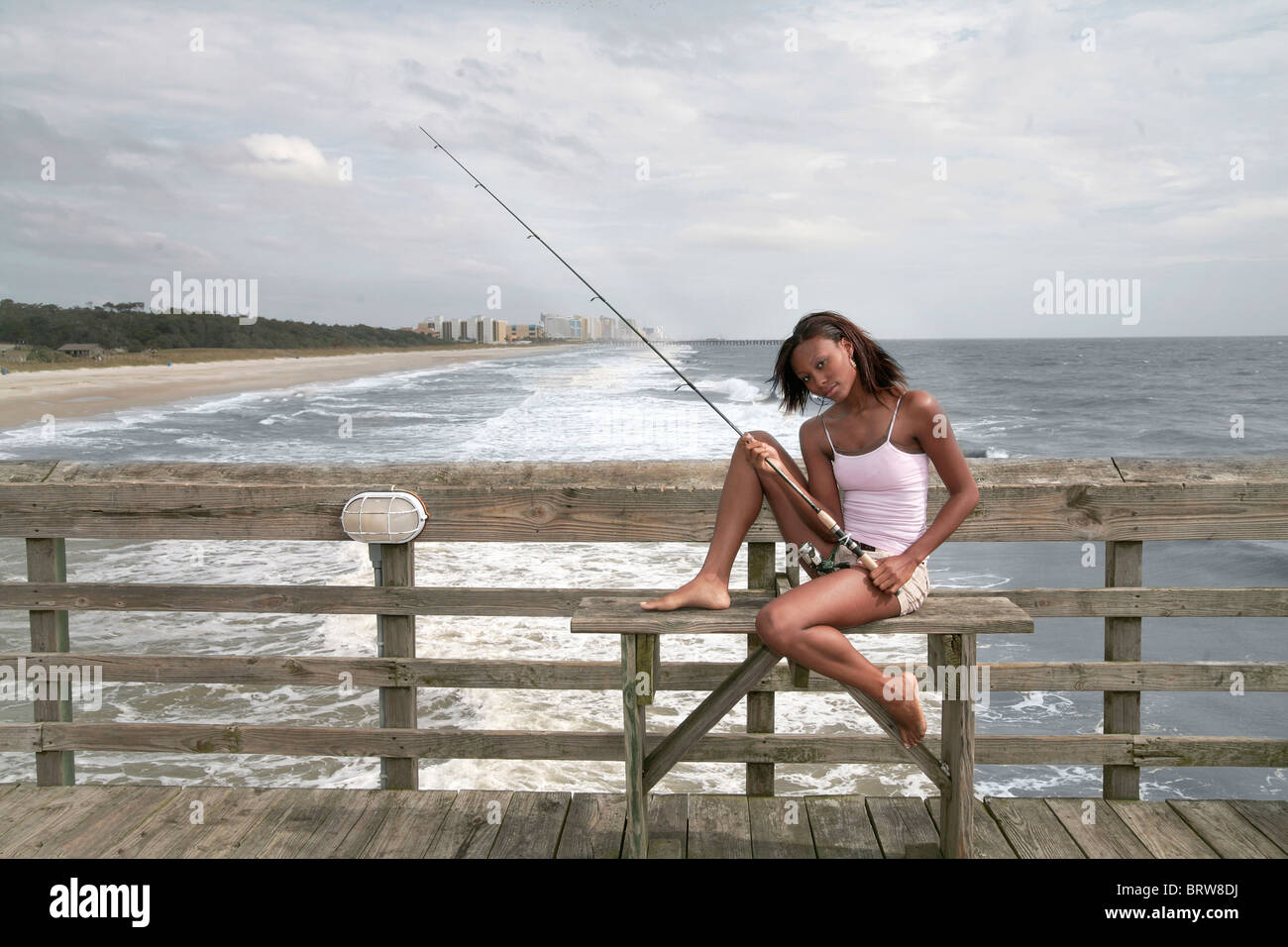 African American twenties woman with a fishing pole at Myrtle