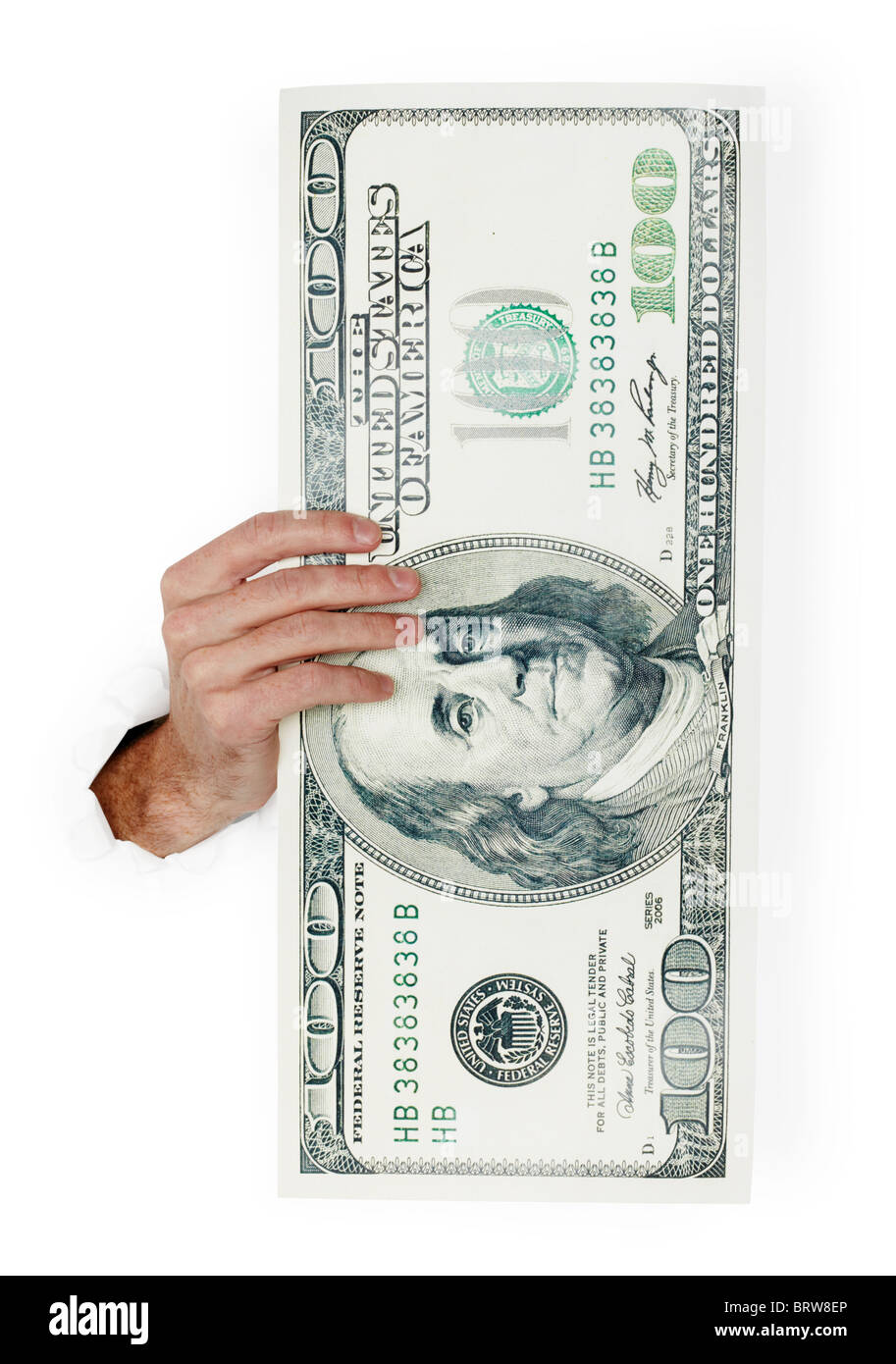 The hand holds huge paper dollar isolated on white background Stock Photo