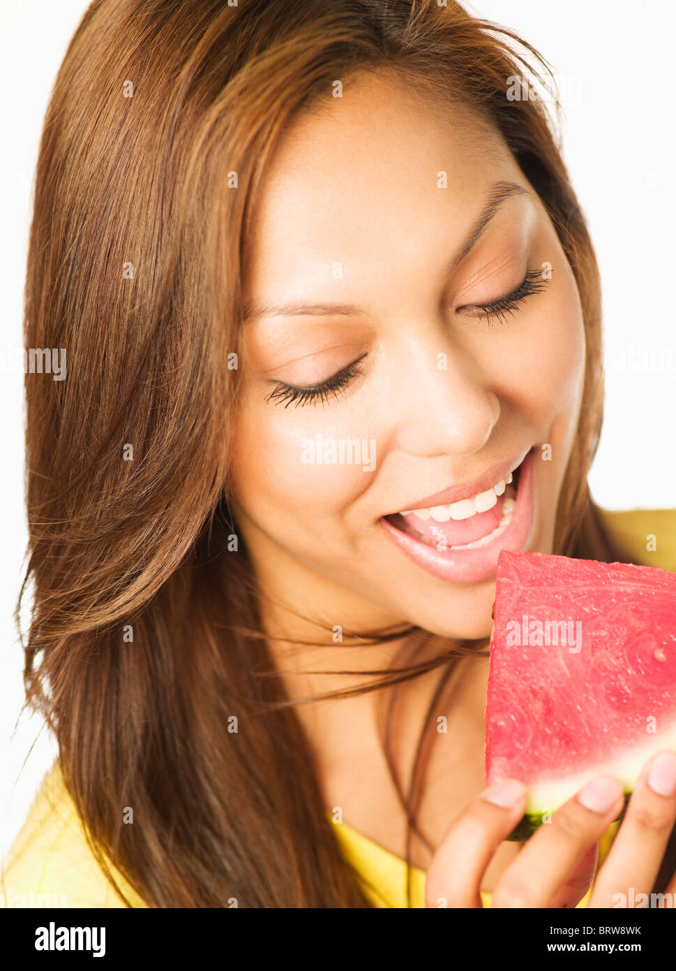 Close up of Hispanic woman eating watermelon Stock Photo