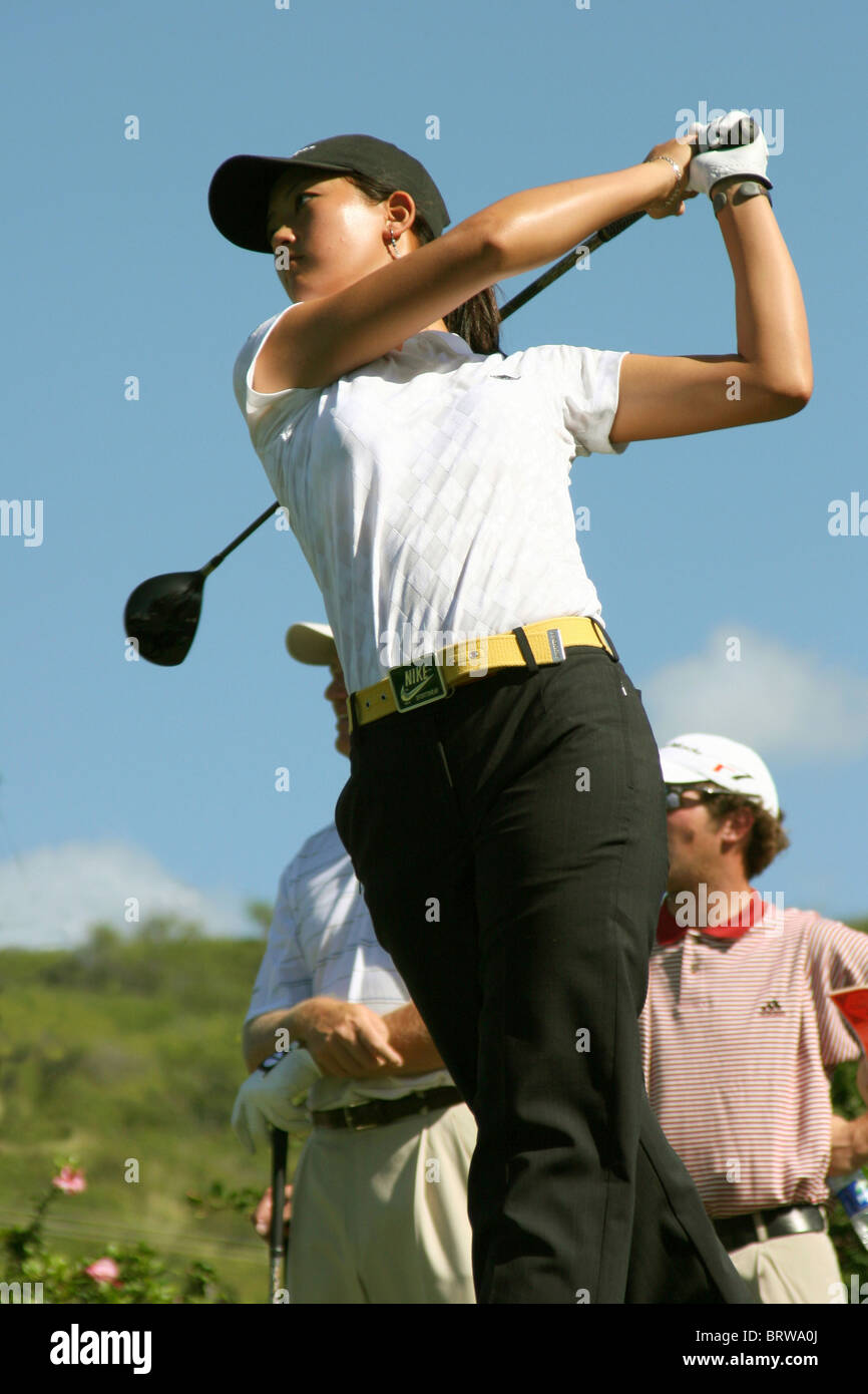 Fifteen year old child golfer Michelle Wie tees off while PGA tour pros watch prior to The 2005 Sony Open In Hawaii Stock Photo