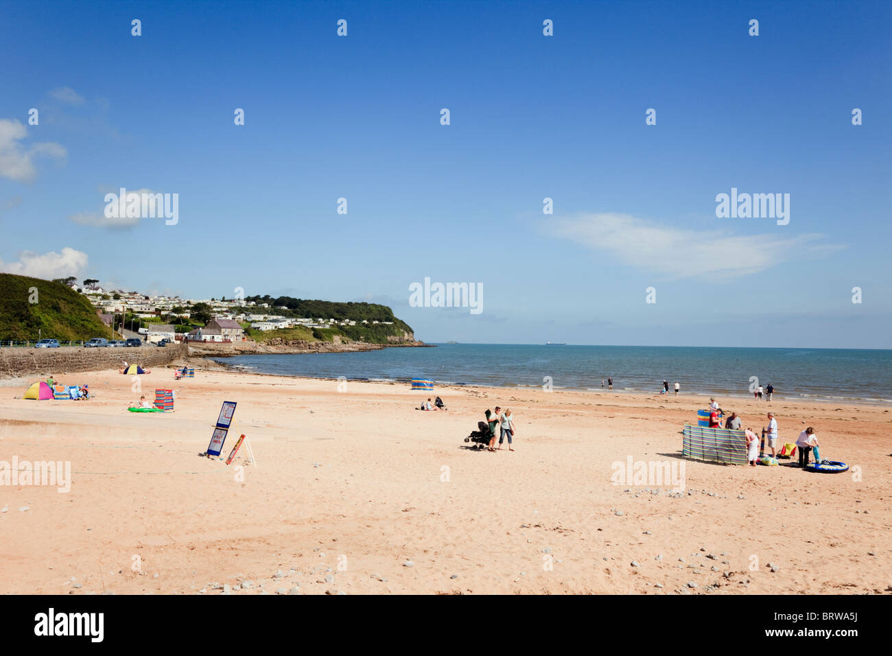 Benllech, Isle of Anglesey, North Wales, UK. Holidaymakers on quiet sandy beach in early summer