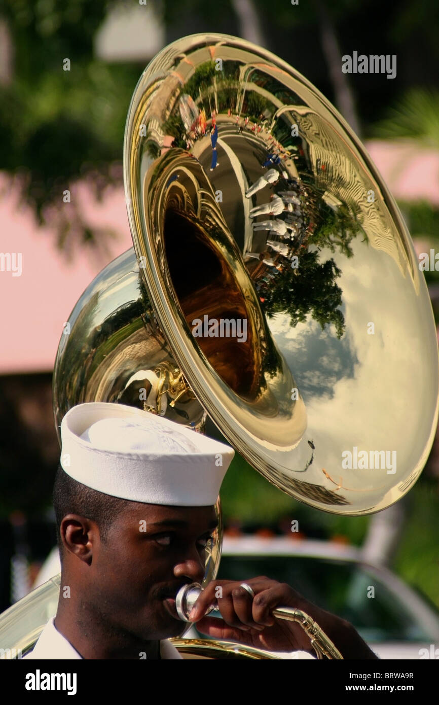 An African-American musician with the US Navy marching band is playing music with a gold reflecting tuba in Honolulu, Hawaii. Stock Photo