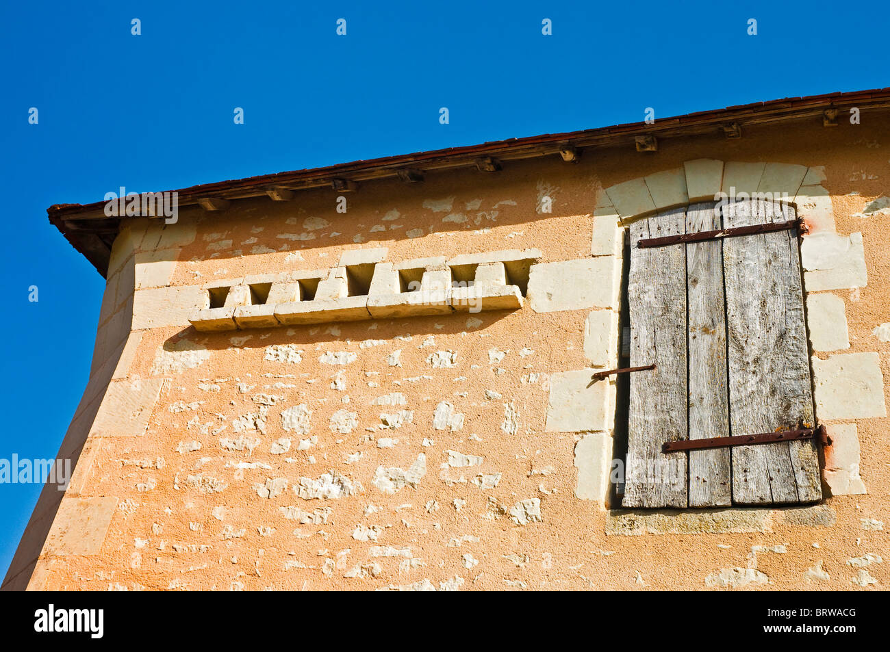 Traditional stone built farmhouse with pigeon loft holes in wall - France. Stock Photo