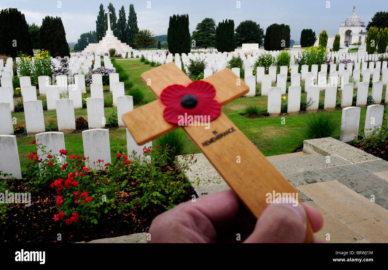 FLANDERS. Tyne Cot Cemetery. A poppy on a miniature wooden cross. Stock Photo