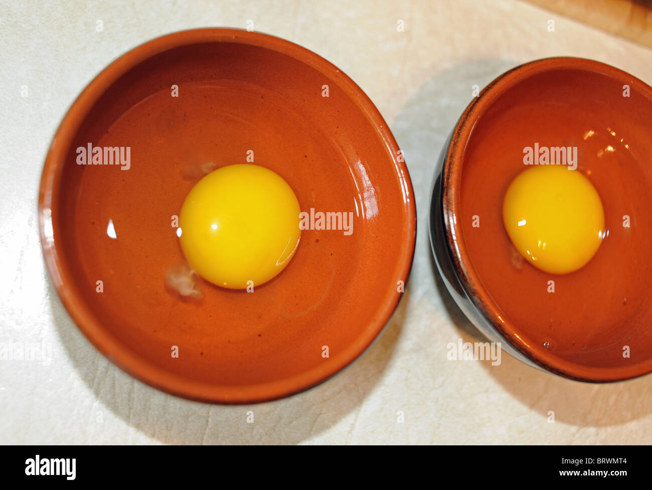 Egg yolks for ready for use in cooking in ramekin dishes in the kitchen Stock Photo Alamy