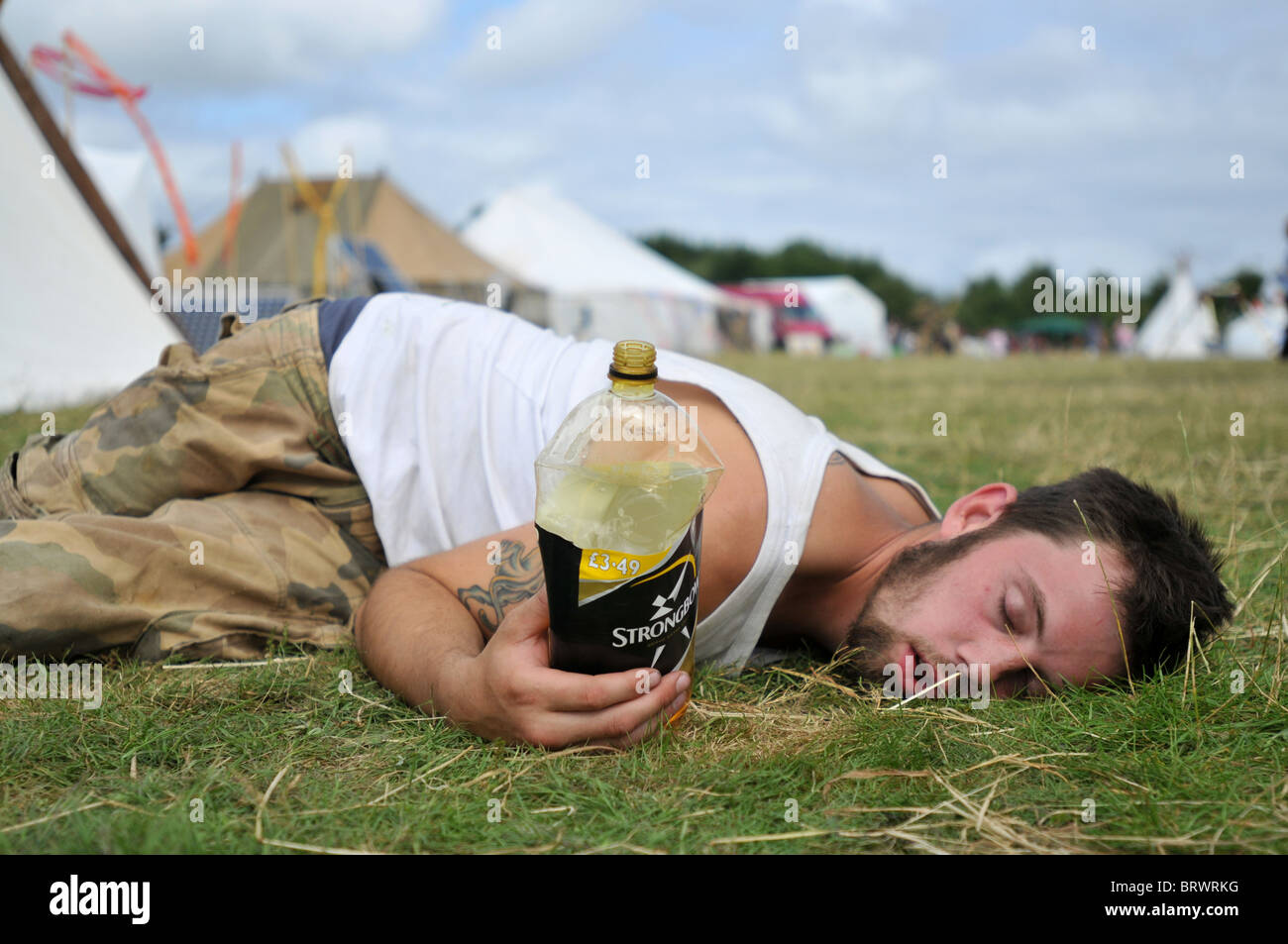 A festival goer in Cornwall, UK succumbs to alcohol Stock Photo
