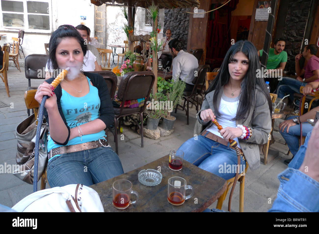 SYRIA Cafe with young women smoking sheesha pies. Damascus. PHOTOGRAPH by Sean Sprague Stock Photo