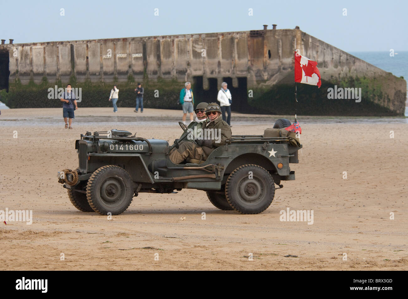 France, Normandy, Arromanches. Vintage jeep with soldiers in uniform. Stock Photo