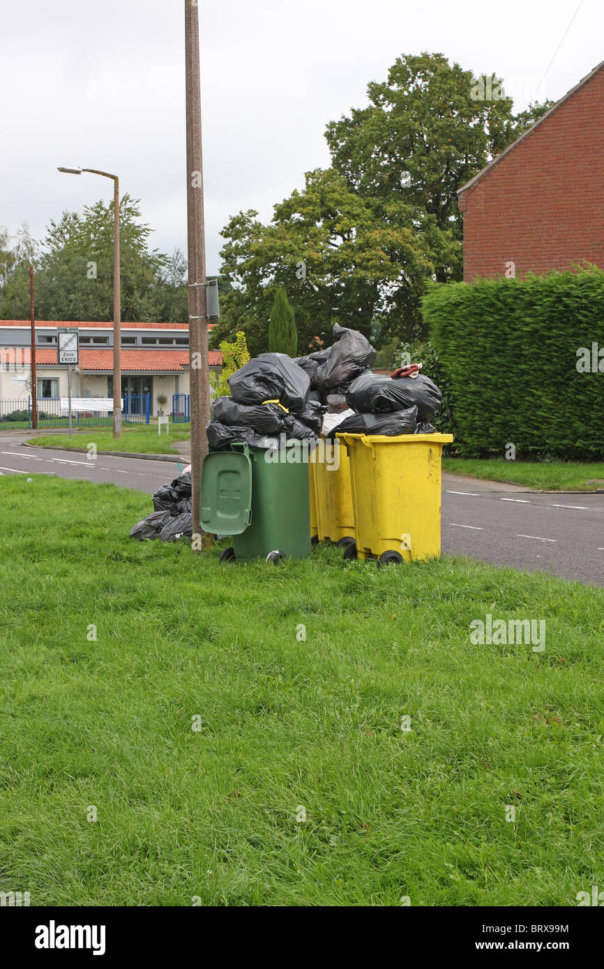 Wheelie bins and bags of rubbish waiting to be collected Stock Photo
