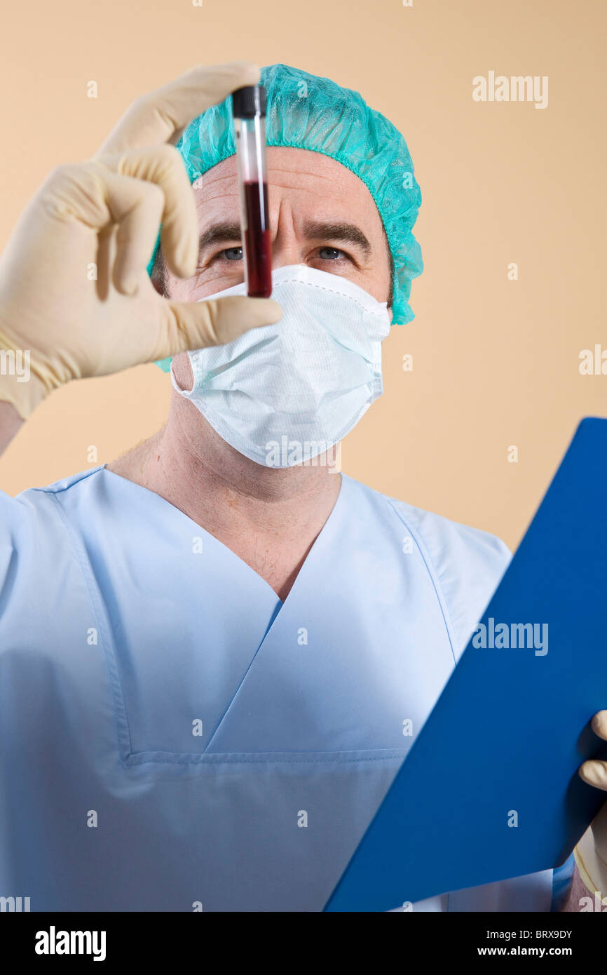 Portrait of a surgeon checking a blood sample test tube Stock Photo Alamy