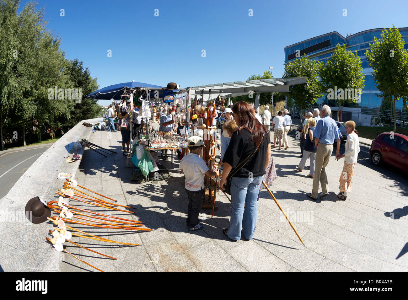 Tourists looking at street stalls selling pilgrim's souvenirs in Santiago de Compostela. Stock Photo