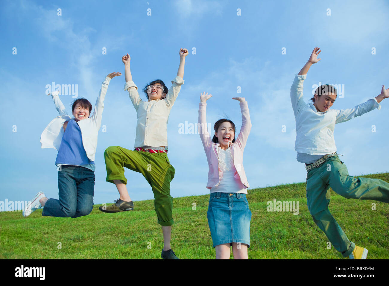 Four Young Women And Men Jumping Of Joy Stock Photo Alamy