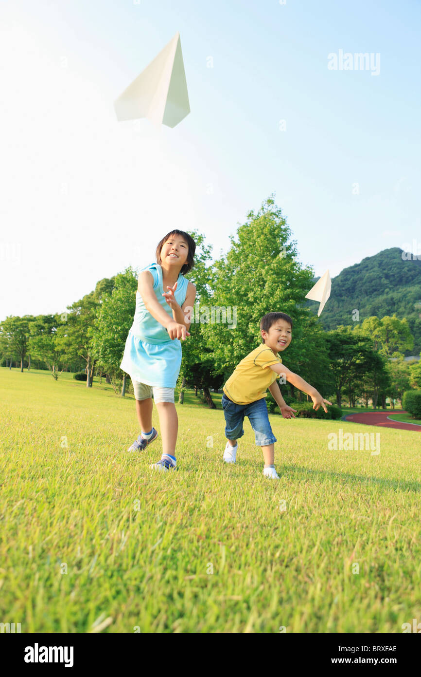Boy and Girl Throwing Paper Airplanes Stock Photo - Alamy