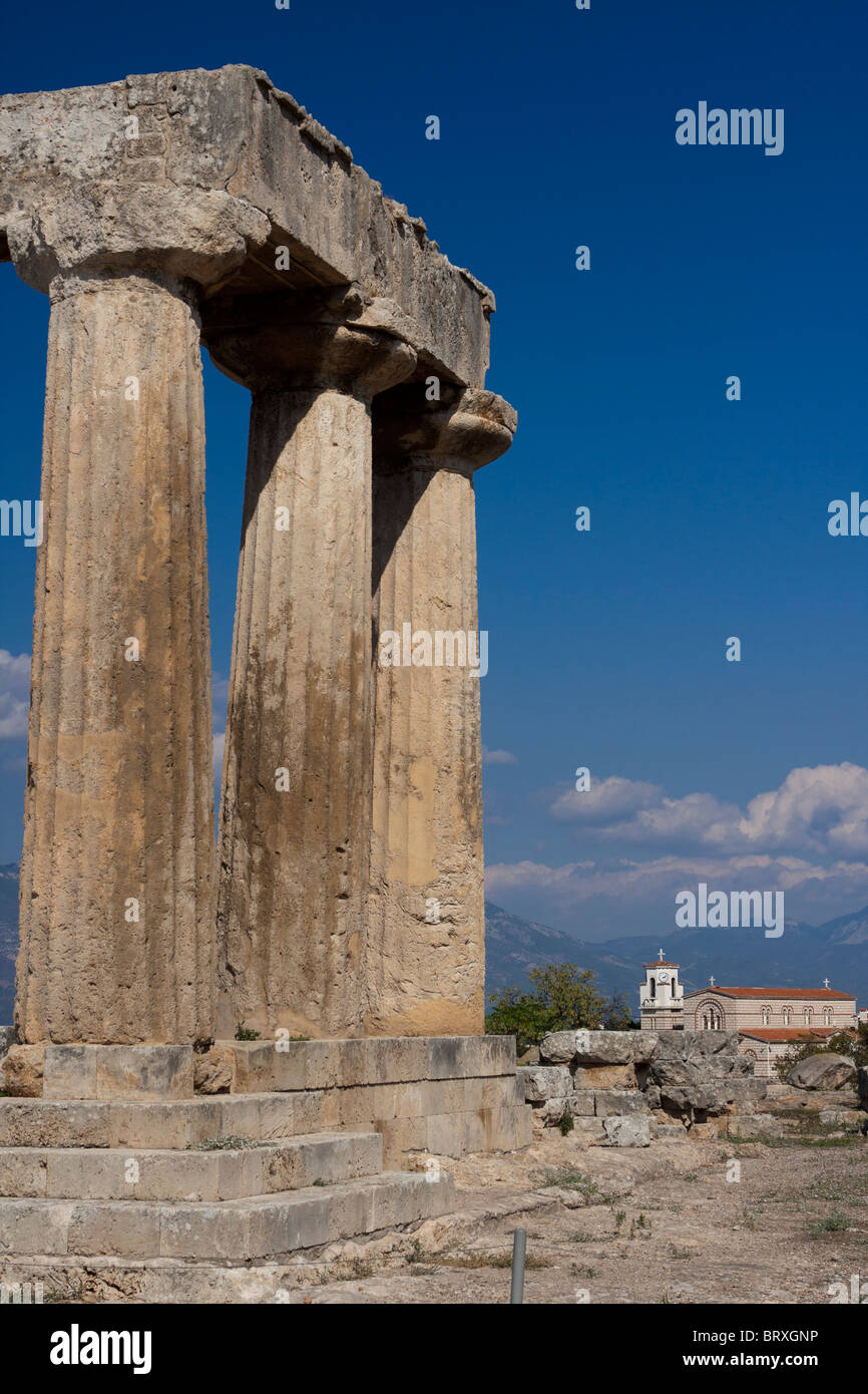 Temple of Apollo in Ancient Corinth and a Greek orthodox church Stock Photo
