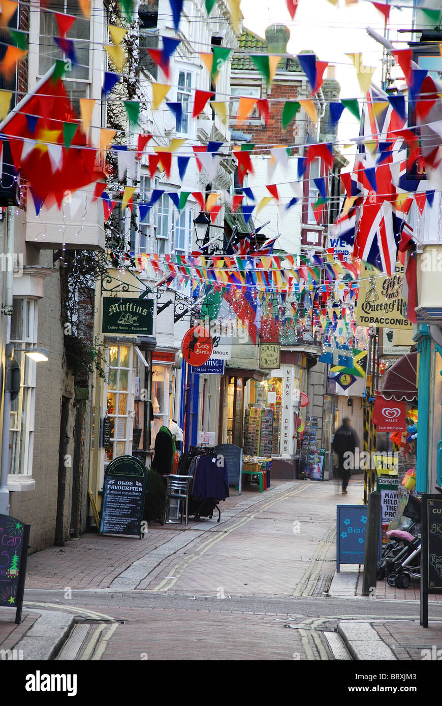 A narrow side street in Weymouth, festooned with bunting and flags
