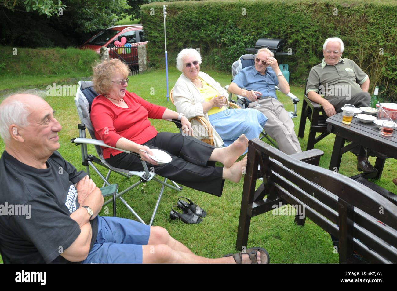 A  family group of English pensioners laughing at a birthday party Stock Photo