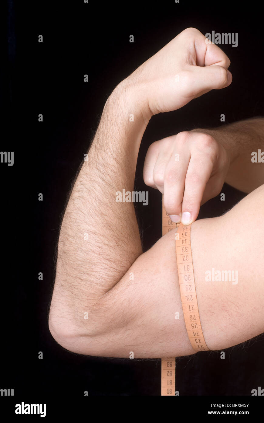 Man measuring bicep Stock Photo Alamy