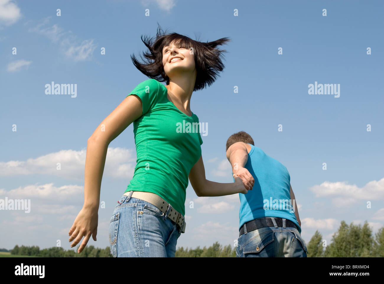 Young couple walking trough field Stock Photo