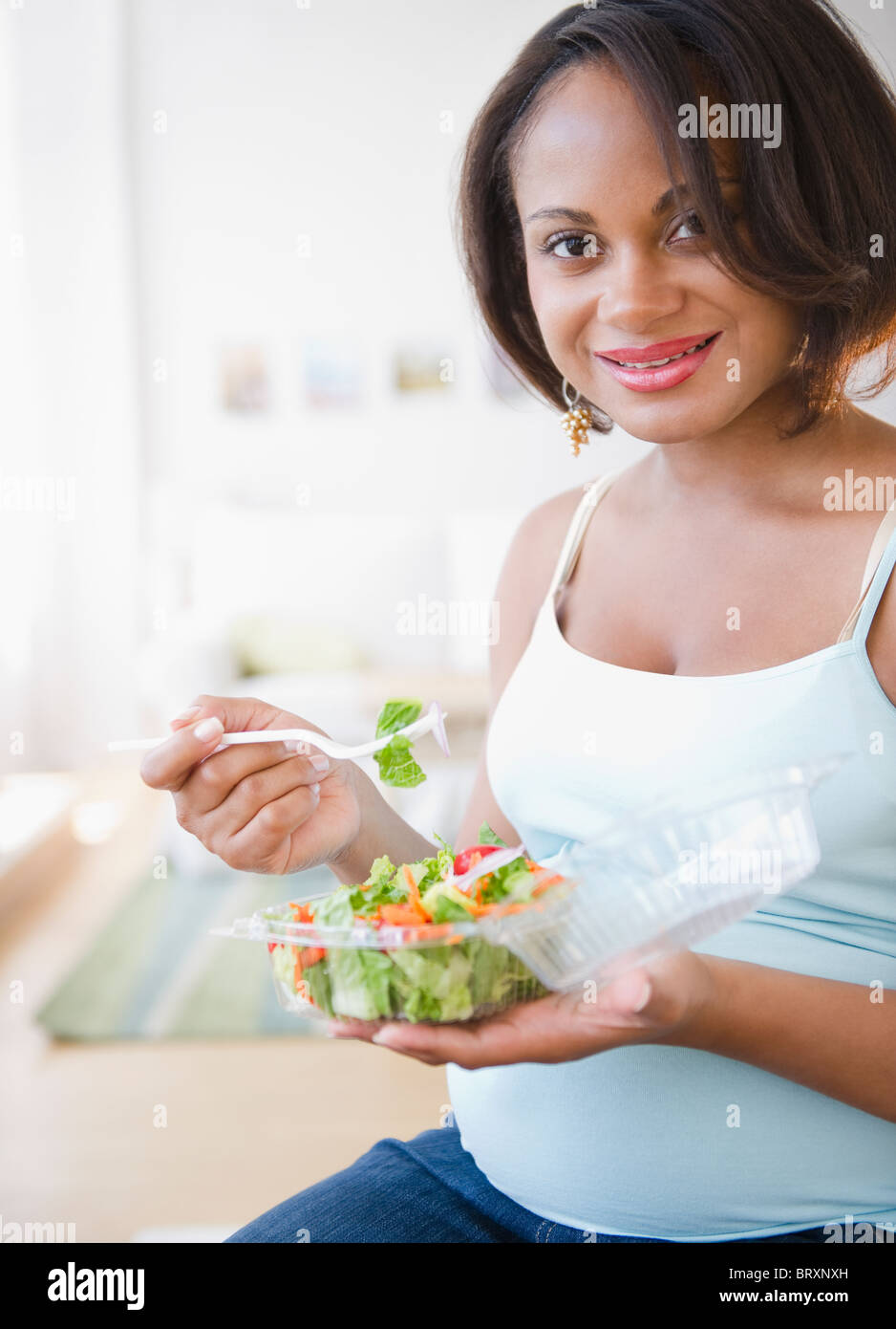 Pregnant Black woman eating salad Stock Photo Alamy