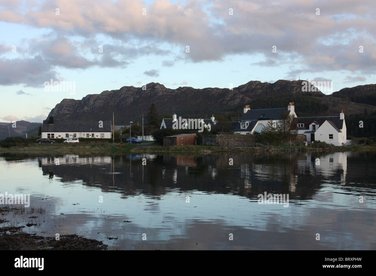 houses in Plockton reflected in Loch Carron Scotland October 2010 Stock
