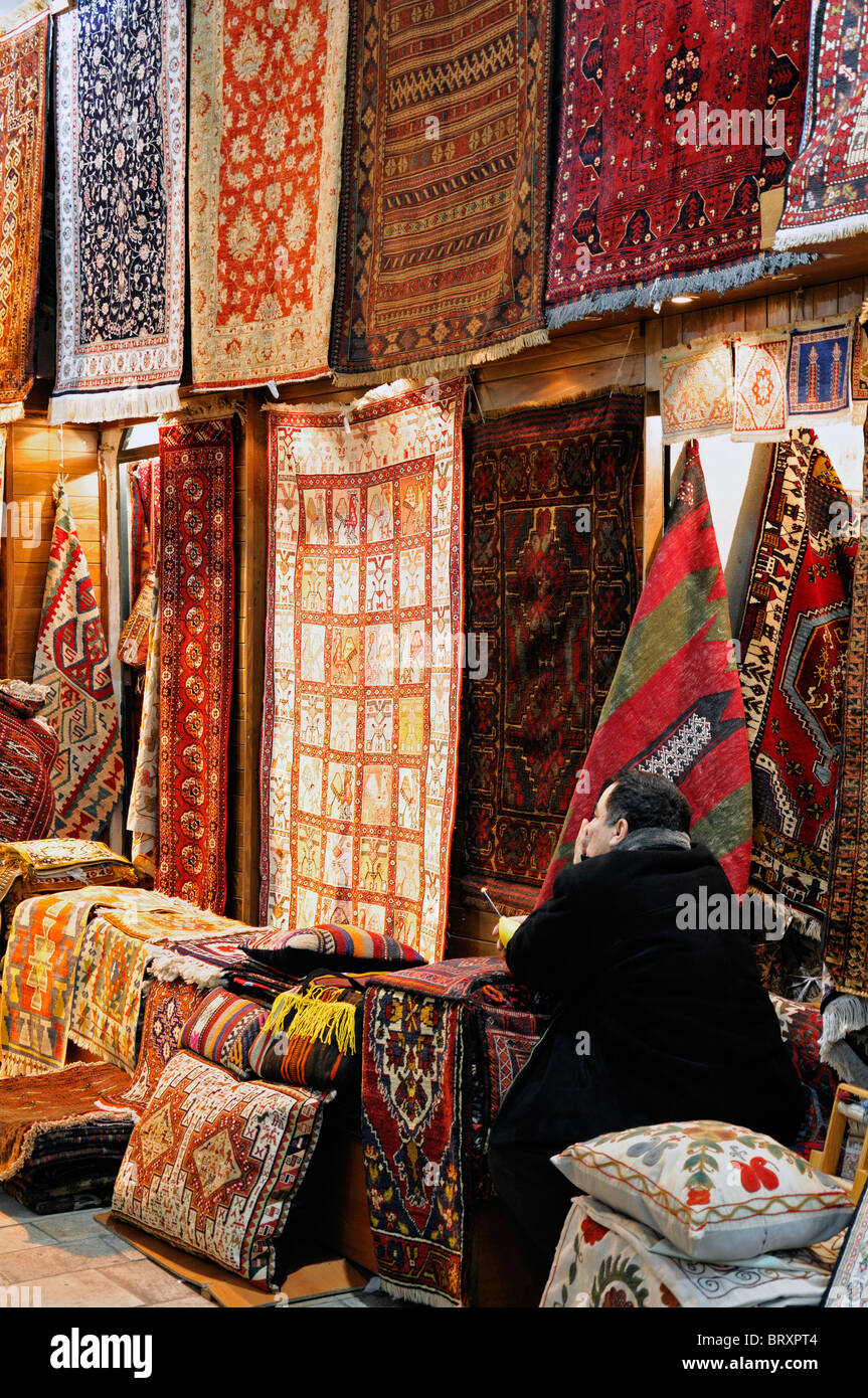 Kapali Carsi or Grand Bazaar of Istanbul, ceramics gifts souvenirs on sale  Turkey carpets prayer mats woven rugs Stock Photo - Alamy