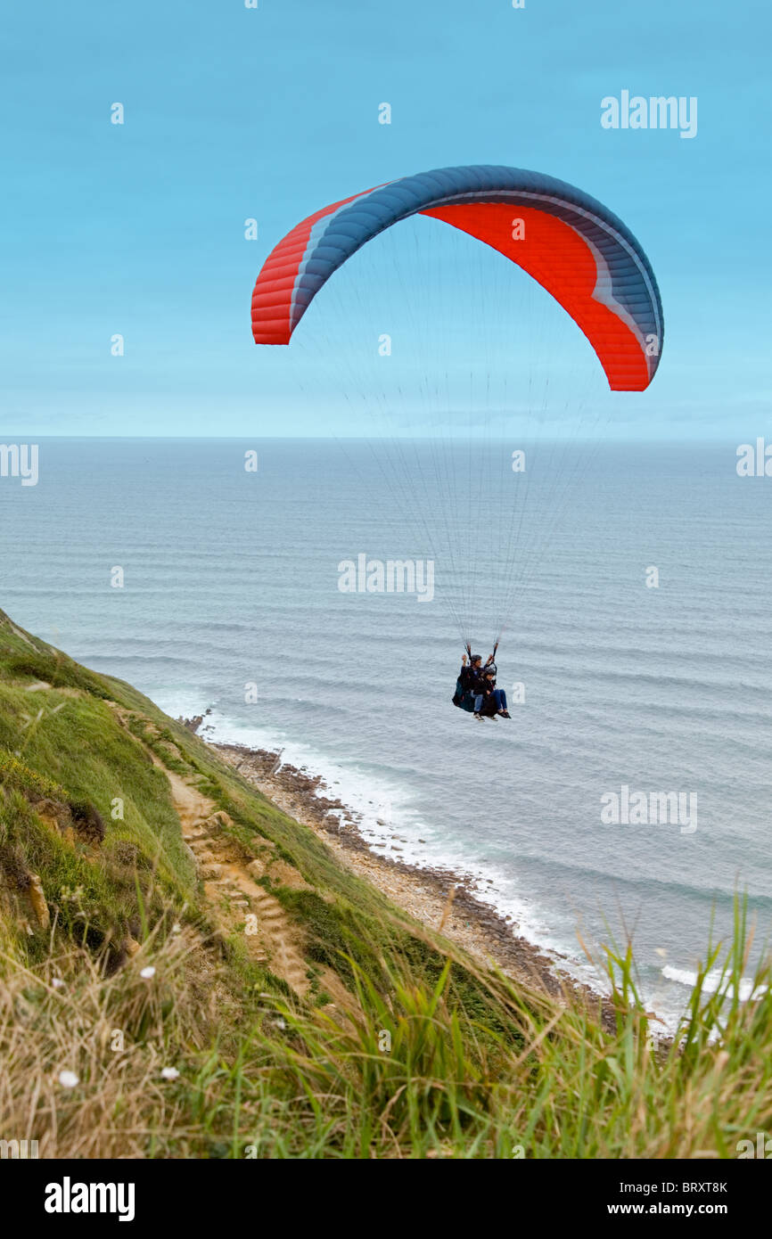 Instructor teaching an apprentice to fly with a paraglide Stock Photo