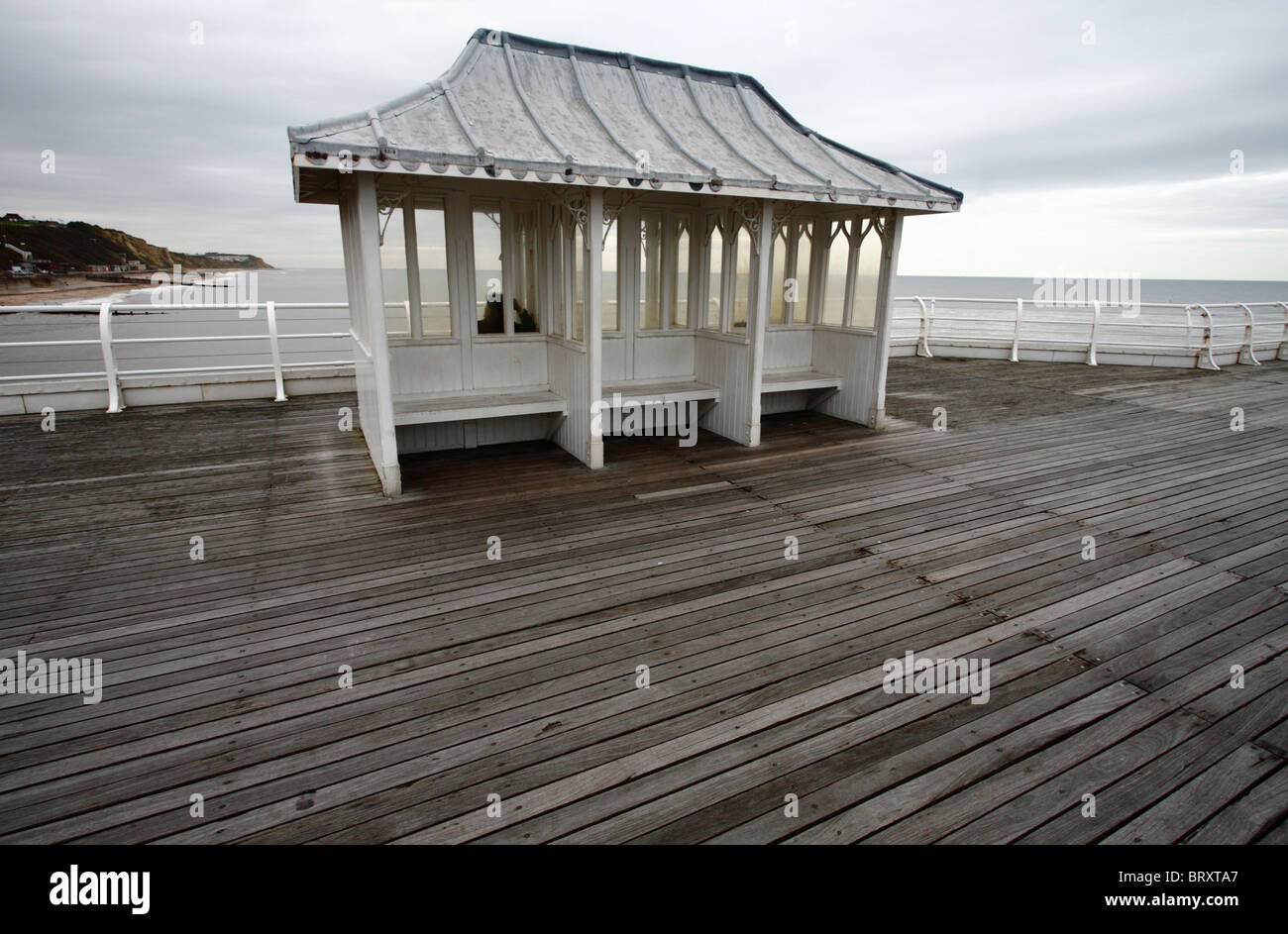 A single man in a small pavilion on Cromer pier. Stock Photo