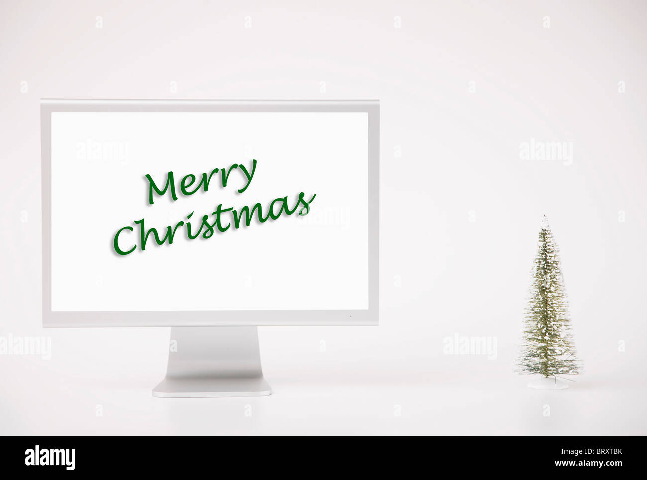 Computer monitor displaying merry Christmas phrase Stock Photo