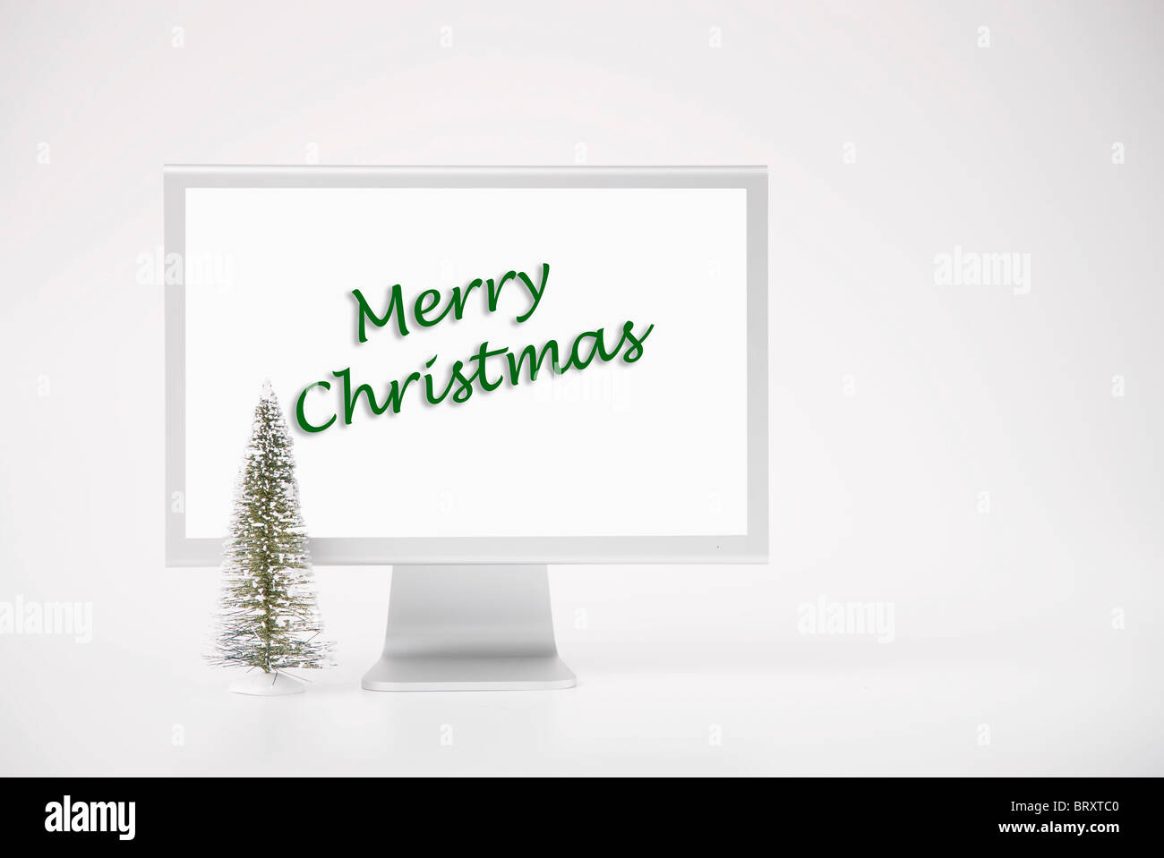 Computer monitor displaying merry Christmas phrase Stock Photo