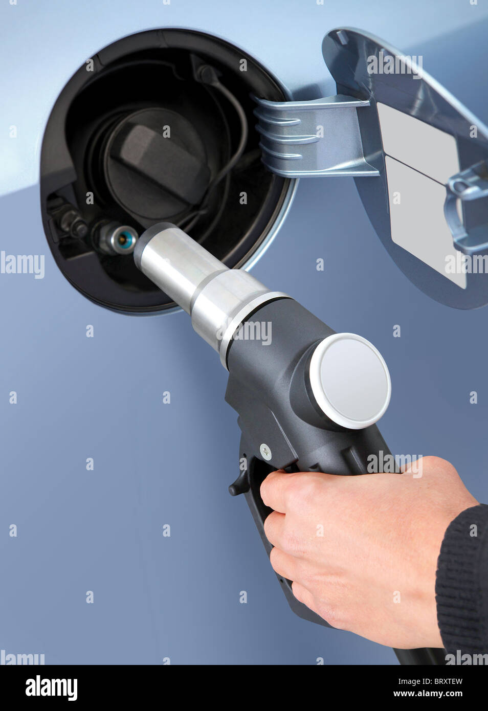 At the gas station pump putting gas into the car Stock Photo Alamy