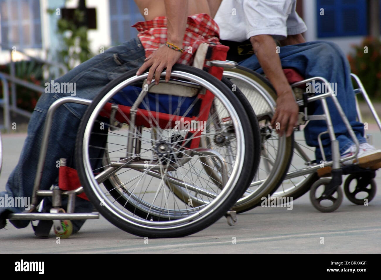 Men hospital patients are playing a game of wheelchair basketball at The National Rehabilitation Center in Vientiane, Laos. Stock Photo