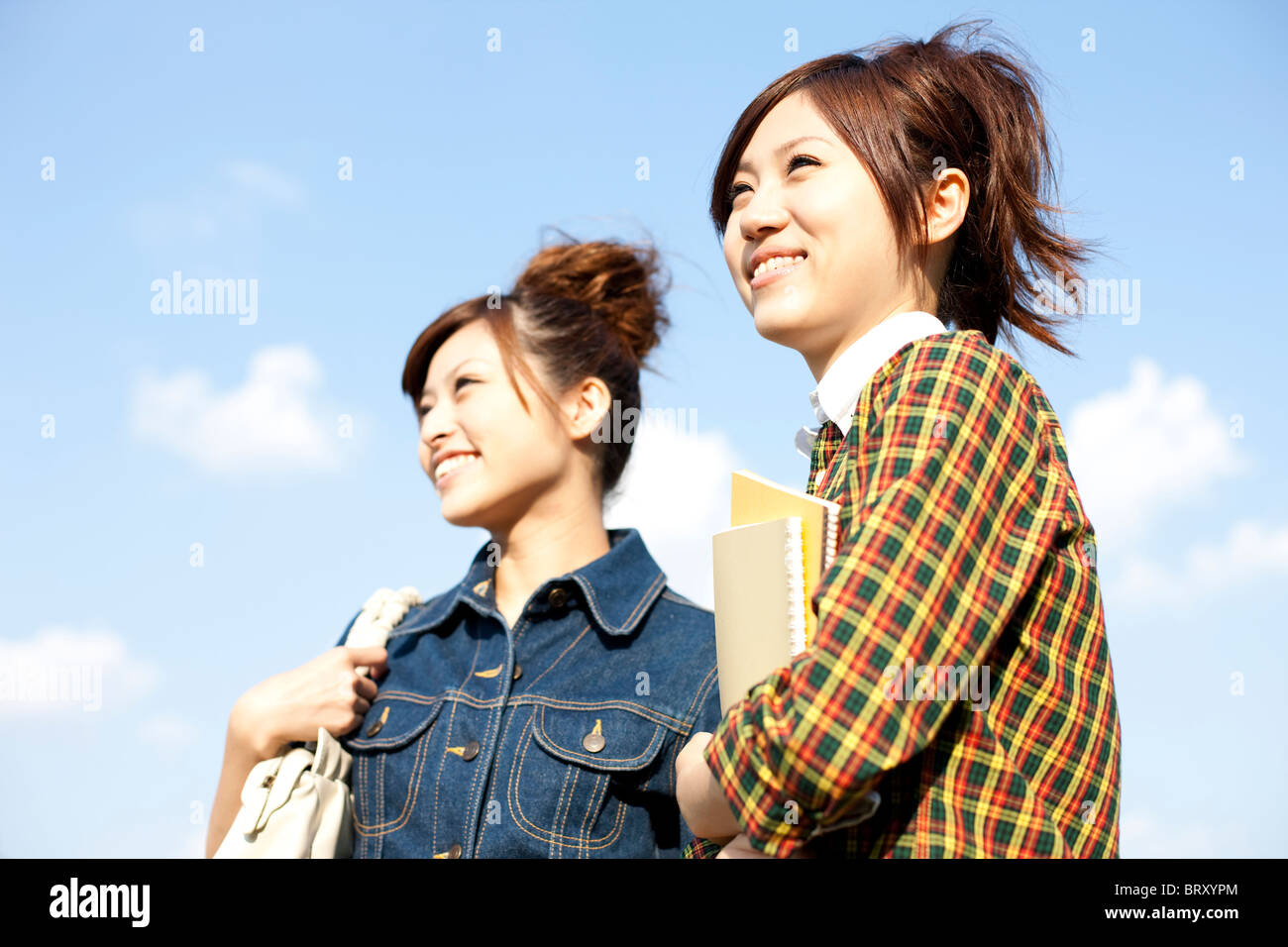 Young women standing holding note pad Japan Stock Photo