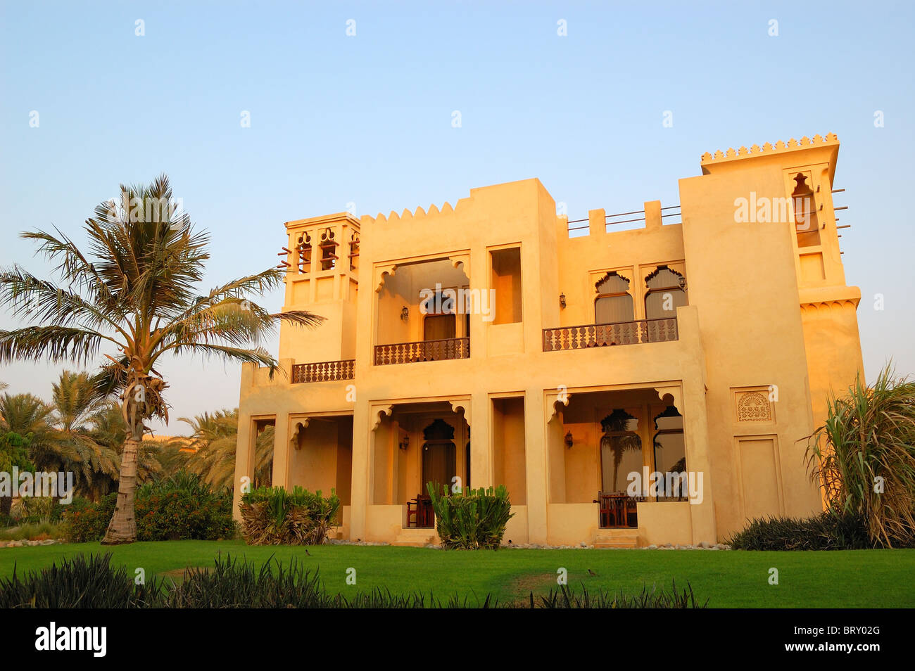 Arabic style villa and palm at luxury hotel, Dubai, UAE Stock Photo