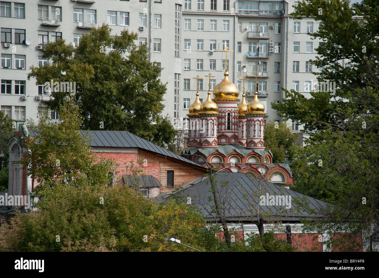Small church surrounded by newbuildings in Moscow, Russia. Stock Photo