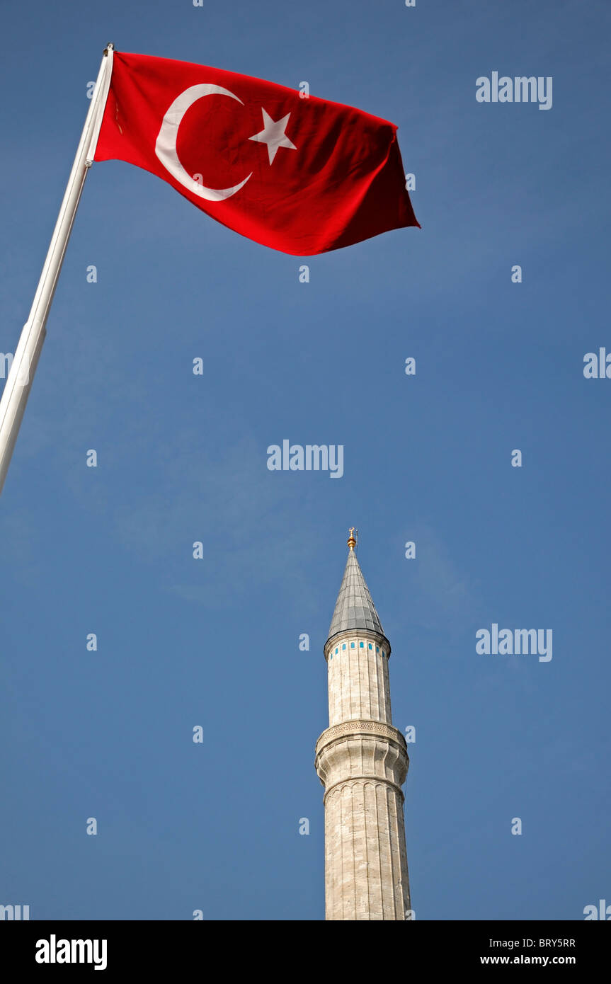 turkish turkey national flag emblem white crescent moon star center Ay Yıldız Albayrak Red flag in front of minaret secularism Stock Photo