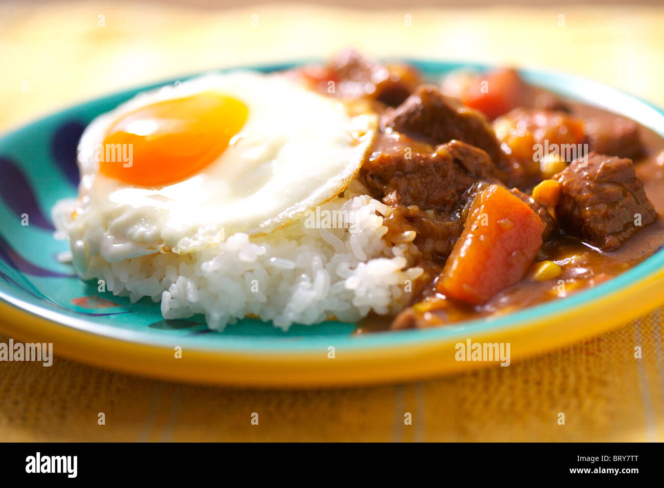 Curry with fried egg Stock Photo Alamy
